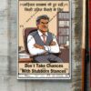 Framed Behaviour Safety Poster 'BSP-1' displayed on a concrete wall. The poster's design features an angry, stubborn-looking man sitting in an office chair with his arms crossed. The text, in English and Hindi, promotes safety by advising: "Don't Take Chances With Stubborn Stances" and "Keep stubborn nature away for an appropriate decision."