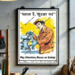 A 'Pay Attention, Focus on Safety' behaviour safety poster (Code: BSP-15) framed and displayed in a workshop or industrial environment. The poster features an illustration of a focused worker in a hardhat and gloves attentively operating a piece of machinery. The message promotes safety awareness in English and Hindi: 'Pay Attention, Focus on Safety' and 'ध्यान दें, सुरक्षा पर'.