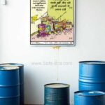 Safe-Era Chemical Storage Management Poster CSP-3 displayed above blue industrial drums, showing organized chemical containers with bilingual storage safety instructions.