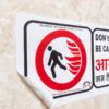 Peel-out view of industrial adhesive safety sticker sheet.